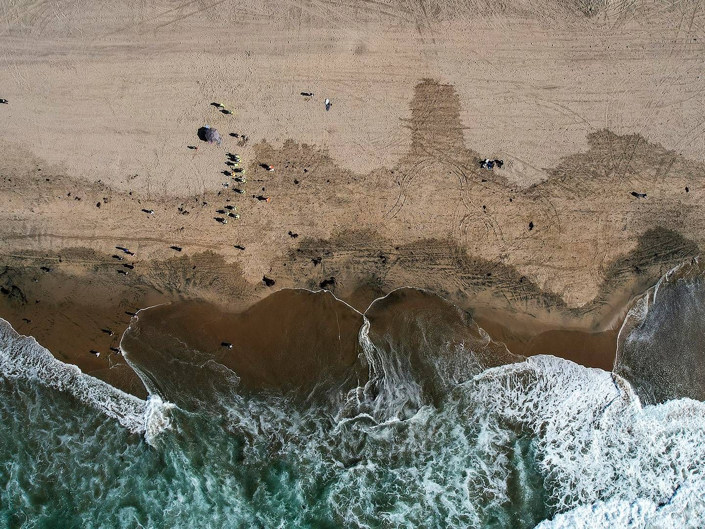 Olie fra udslippet ved Orange County i Californien blive renset fra en strand i Huntington Beach i oktober 2021. | Foto: Ringo H.w. Chiu/AP/Ritzau Scanpix