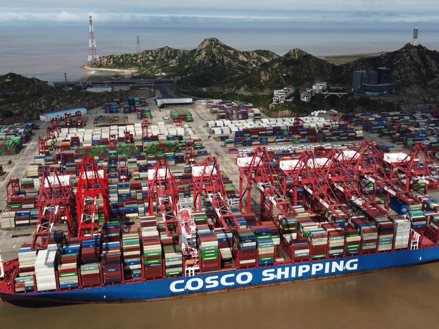 Et containerskib fra kinesiske Cosco Shipping Holdings i havnen i Shanghai. | Foto: Stringer/Reuters/Ritzau Scanpix
