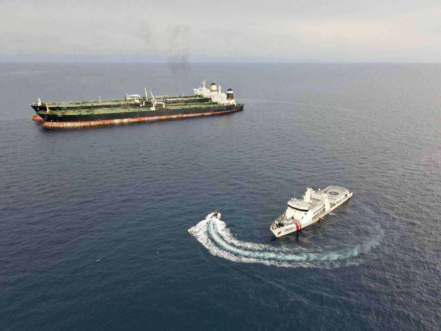 An Indonesian patrol vessel inspects Iranian-flagged tanker MT Arman 114 and the Cameroon-flagged, MT S Tinos, as they were seen transferring oil from ship to ship without authorization near Indonesia's northern Natuna Sea, according to Indonesia's Maritime Security Agency (Bakamla).