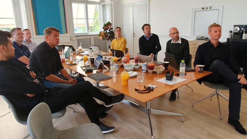 Max Sejbæk, længst til højre, Mikkel Aude nummer tre fra højre. Til venstre i blå polo er Henrik Kim Christensen og endelig Peter Skjødt, der læser sig ind over bordet. De øvrige er managerer i Proactive. | Foto: Jakob Skouboe