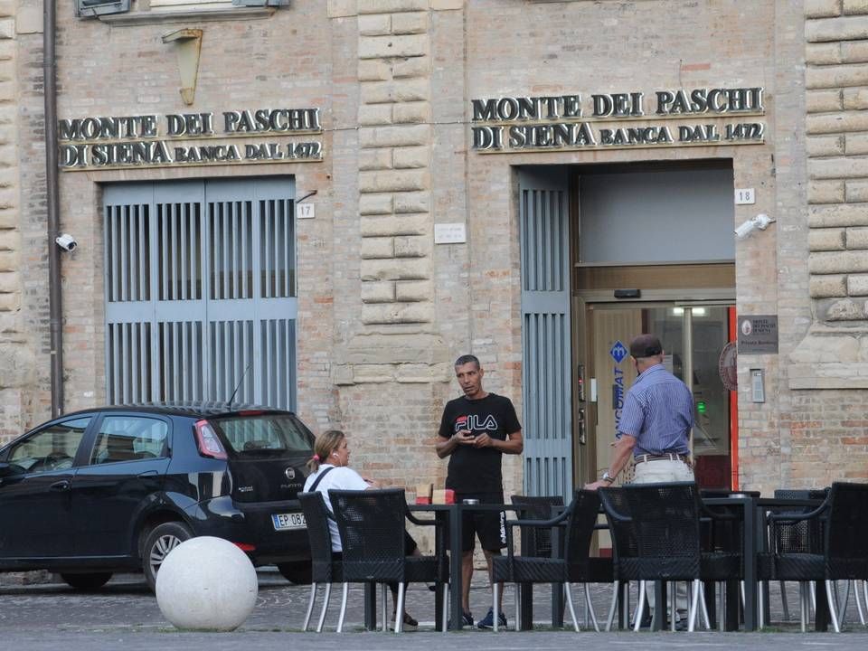 Menschen im Gespräch vor einer Filiale der Bank Monte dei Paschi di Siena in Pesaro, Italien | Foto: picture alliance / ROPI | Antonio Pisacreta