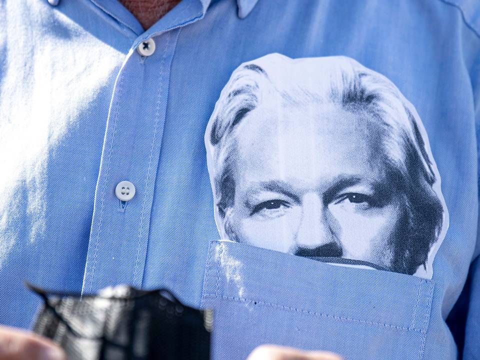 En deltager i en demonstration 3. juli i Berlin for løsladelsen af Julian Assange har puttet en Assange-maske i brystlommen. | Foto: Fabian Sommer/AP/Ritzau Scanpix