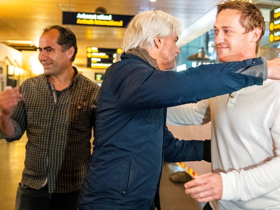 NRK's sportschef Egil Sundvor tager imod journalisterne Lokman Ghorbani og Halvor Ekeland i Oslo, hvor de landede onsdag fra Qatar, hvor de blev anholdt | Foto: Hakon Mosvold Larsen/AFP/Ritzau Scanpix