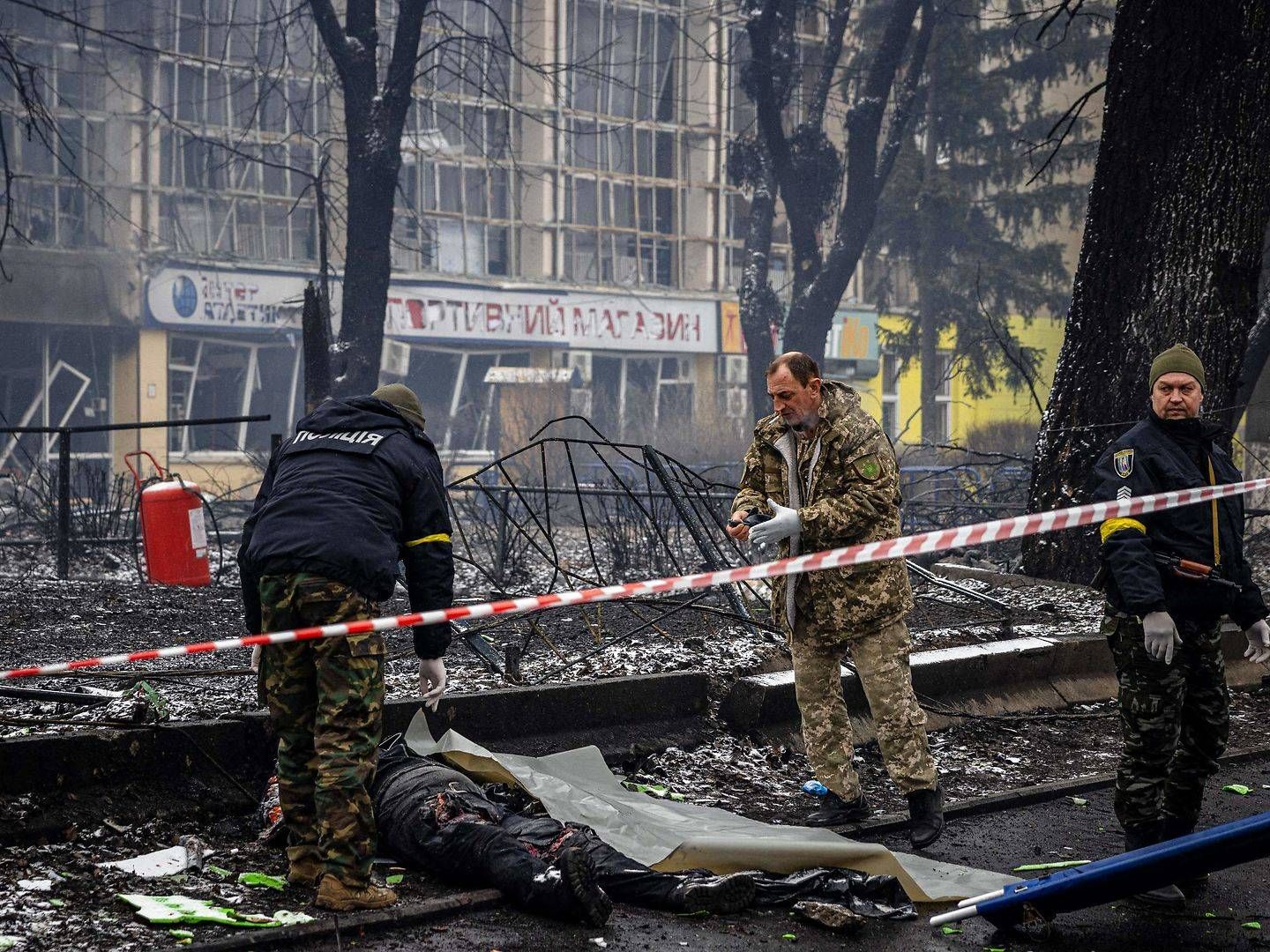 Police officers remove the body of a passerby killed in yesterday's airstrike that hit Kyiv's main television tower in Kyiv on March 2, 2022. | Photo: Dimitar Dilkoff/AFP/Ritzau Scanpix