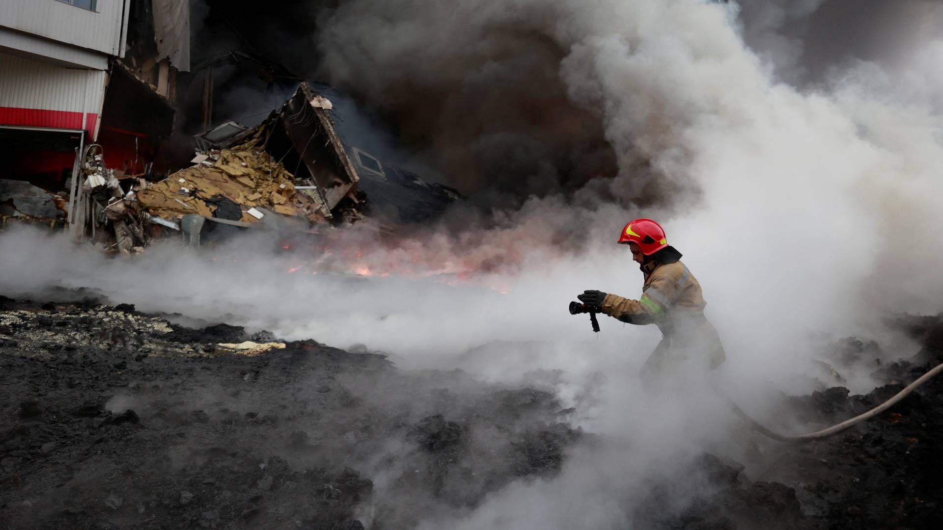 En ukrainsk brandmand slukker torsdag en brand i byen Chaiky uden for hovedstaden Kyiv. | Foto: Serhii Nuzhnenko/REUTERS / X06896