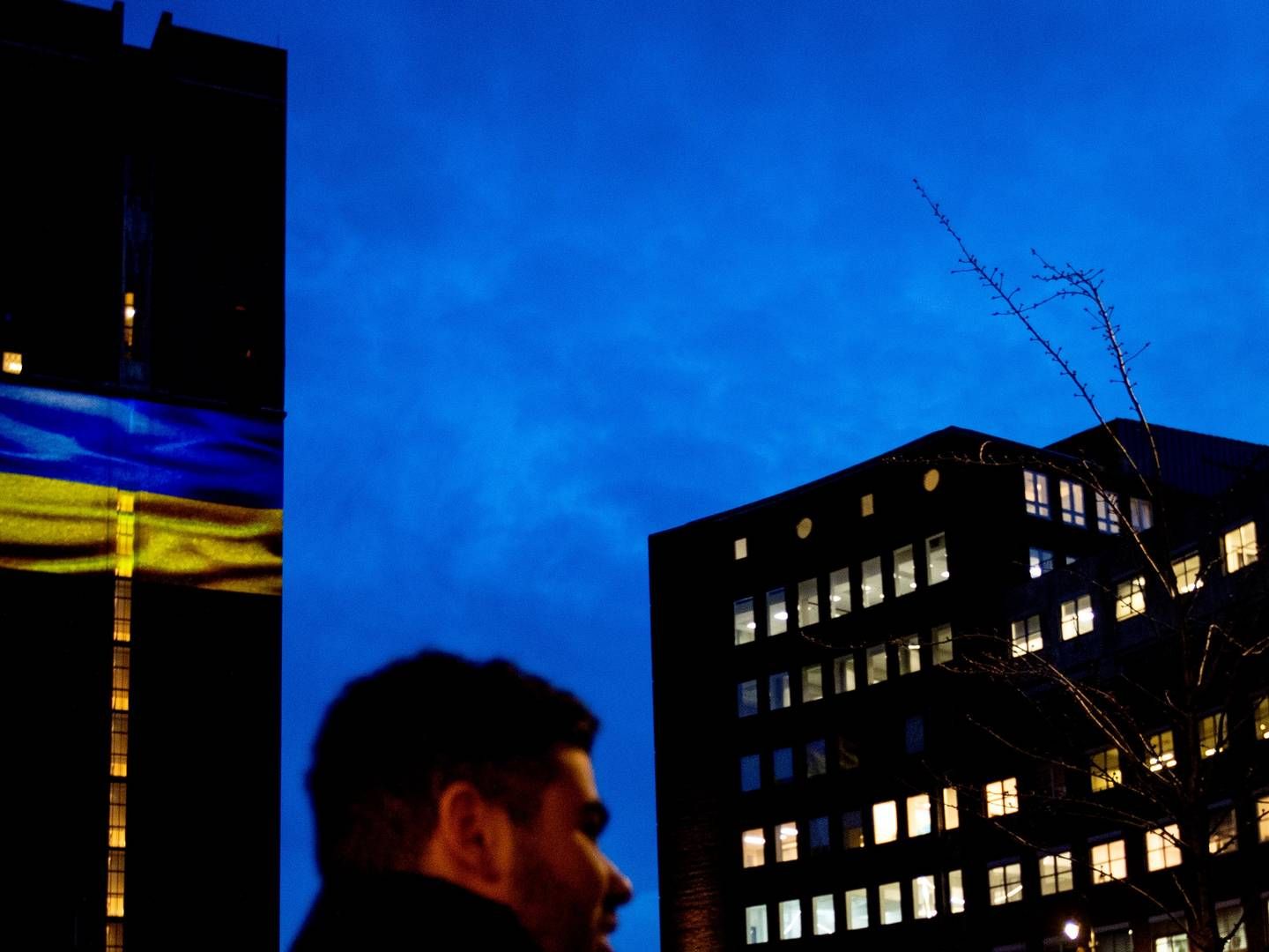 FARGET: Her er Oslo rådhus lyssatt med Ukrainas blå og gule flagg, som i likhet med mange andre bygg verden over har ønsket å gjøre dette for å støtte landet etter den russiske invasjonen. Krigen som pågår for fullt på bakken skaper også store implikasjoner for verdensøkonomien, som Malling & Co skriver om i sin siste rapport. | Foto: Javad Parsa, NTB