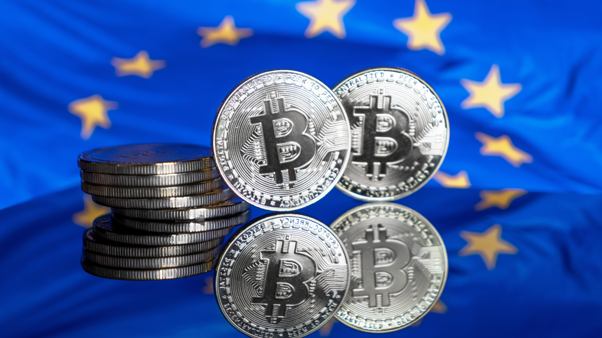 Bitcoin vor einer Europa-Flagge (Symbolbild) | Foto: picture alliance / Daniel Kalker