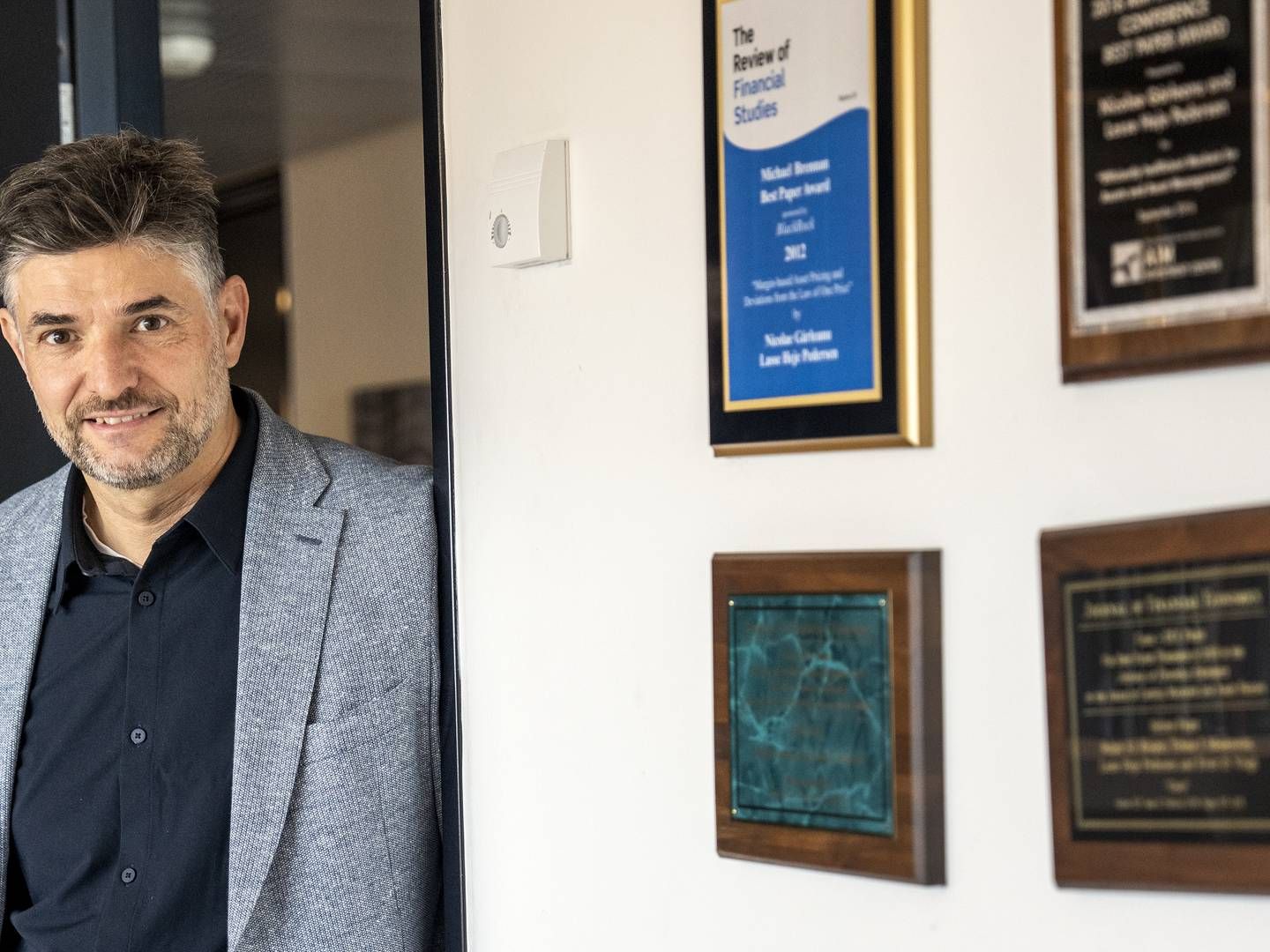 Lasse Heje Pedersen now works at Copenhagen Business School (CBS), where his office is decorated with his various awards and plaques. | Photo: Stine Bidstrup/ERH