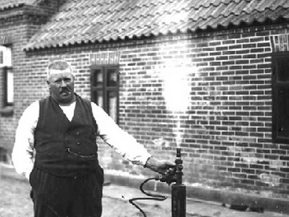 Fiskeeksportør Rasmus Clausen med cigar i munden åbner for sin gasbrønd på gårdspladsen i Strandby. | Foto: Nordjyllandsk Kystmuseum